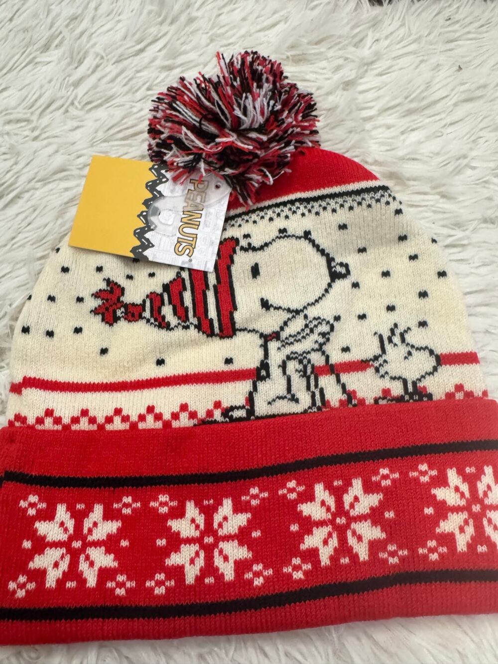Snoopy Christmas beanie with white snowflake pattern on red background